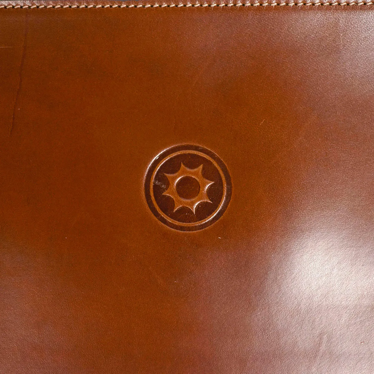 Brown leather portfolio with green zipper